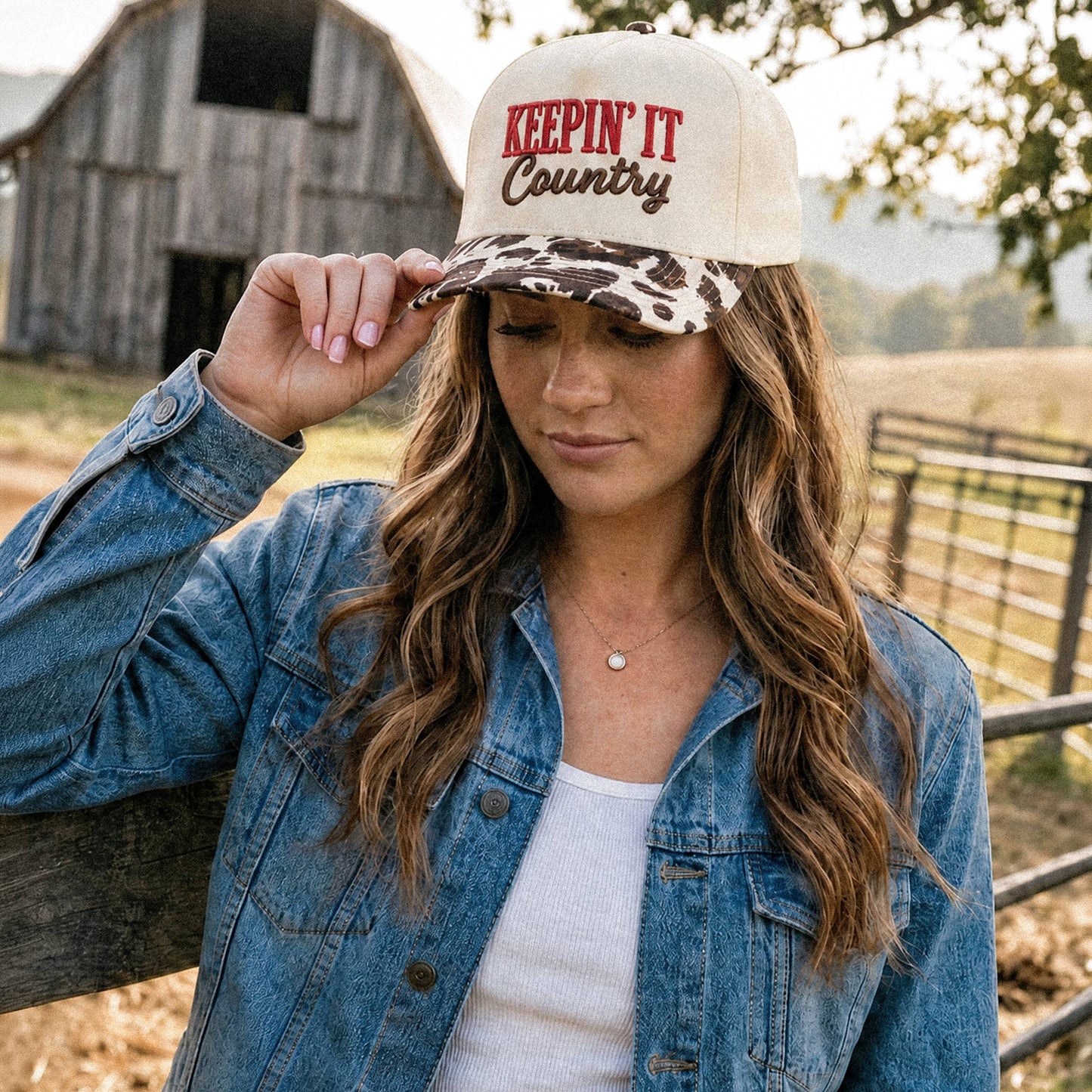 Keepin’ it County Embroidered Two Tone Cow Print Trucker Hat